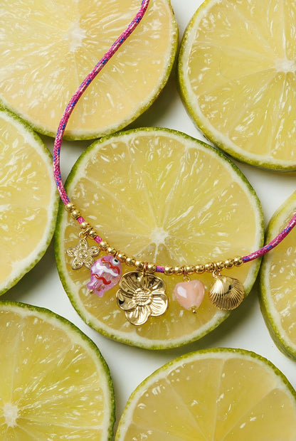Colorful cord necklace with varying pendants and fish pendant